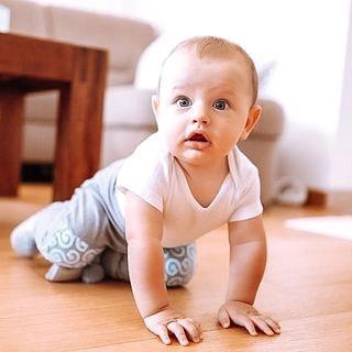 Baby crawling in Geckoeco grip clothing